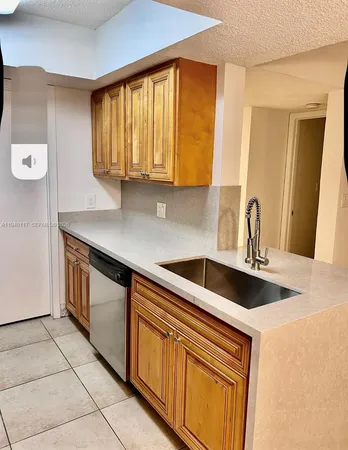 a kitchen with stainless steel appliances a stove a microwave and a refrigerator