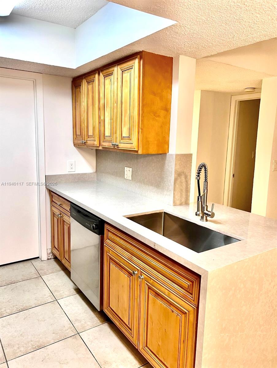 5654 Rock Island Road, Unit 214 Tamarac, FL 33319 - Photo 21 of 26 a kitchen with granite countertop a sink and a stove