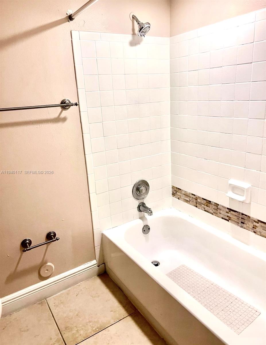 5654 Rock Island Road, Unit 214 Tamarac, FL 33319 - Photo 22 of 26 a bathroom with a tub and a shower