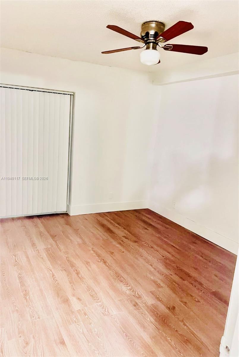5654 Rock Island Road, Unit 214 Tamarac, FL 33319 - Photo 24 of 26 an empty room with a ceiling fan and a window