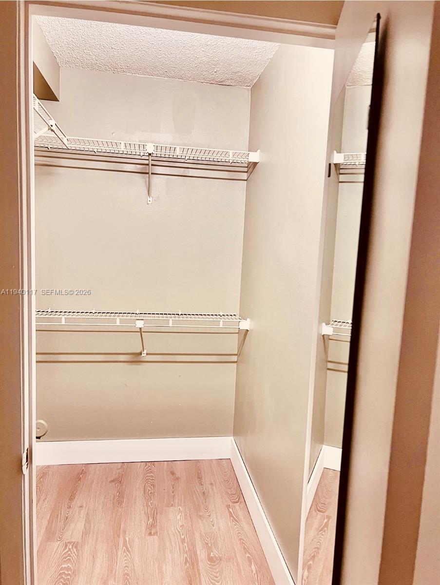 5654 Rock Island Road, Unit 214 Tamarac, FL 33319 - Photo 25 of 26 a view of a closet with wooden floor