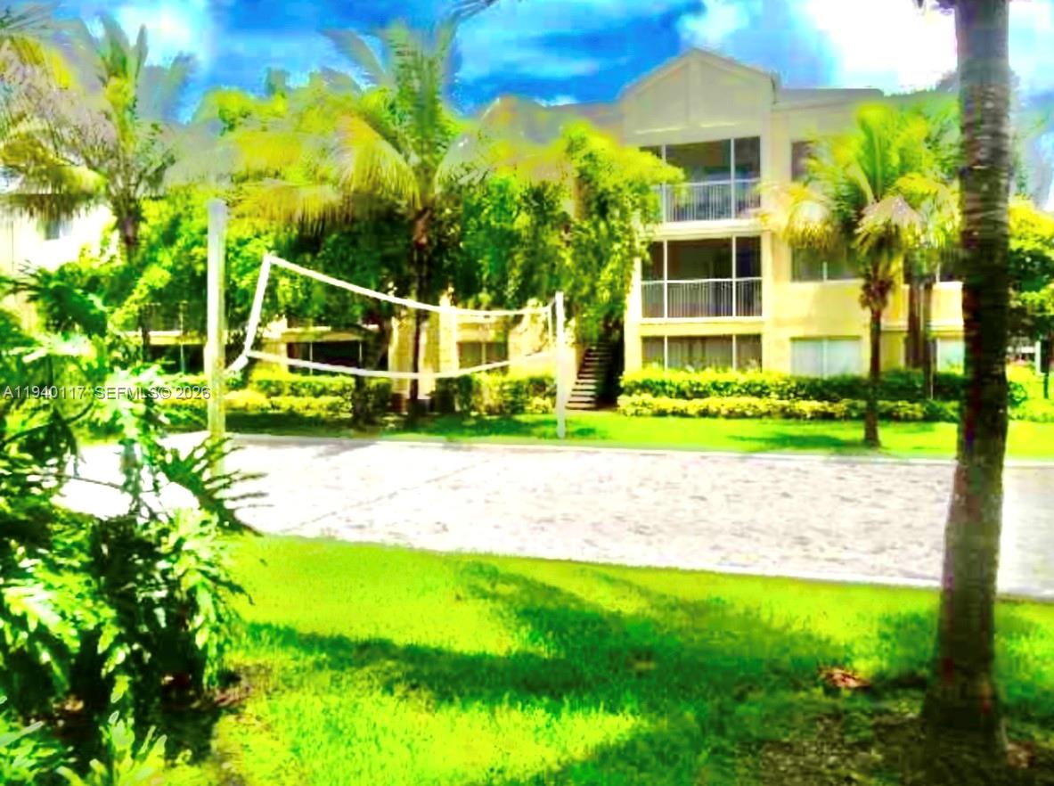 5654 Rock Island Road, Unit 214 Tamarac, FL 33319 - Photo 6 of 26 a view of a yard with plants and palm trees
