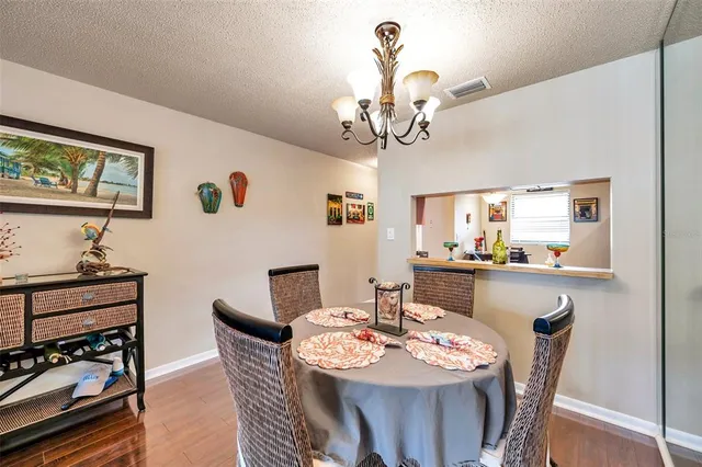 a view of a dining room with furniture wooden floor and a chandelier
