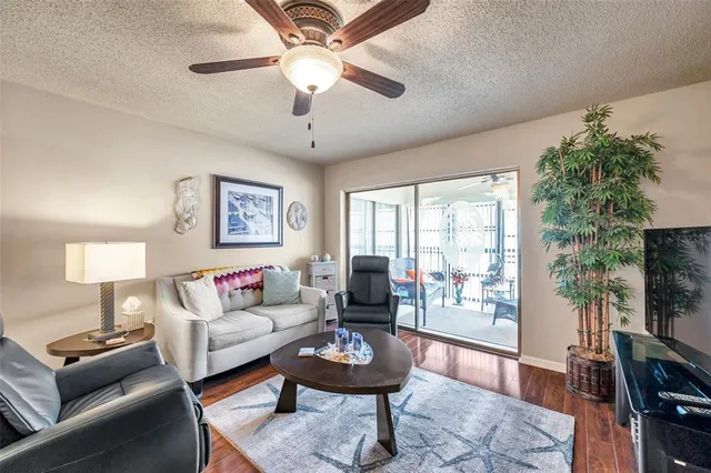 a living room with furniture a flat screen tv and a window