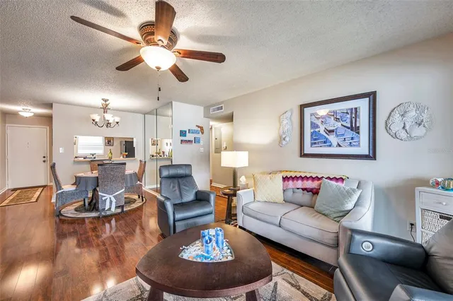 a living room with furniture and a chandelier