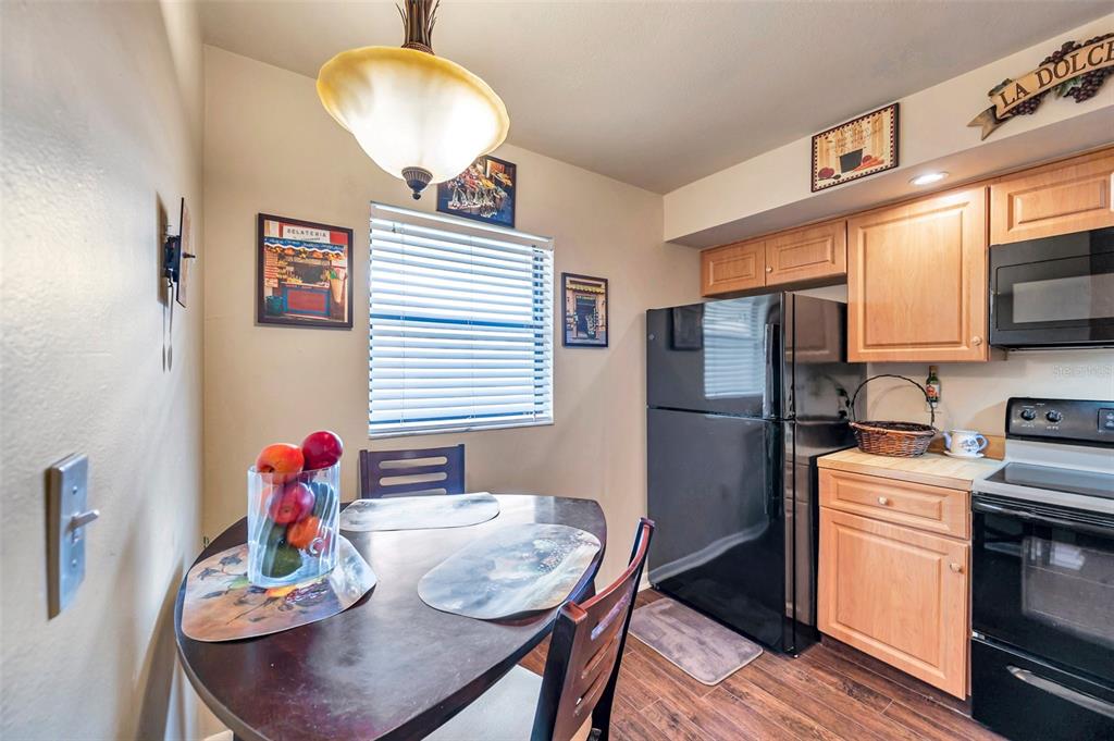 2700 Nebraska Avenue, Unit 3201 Palm Harbor, FL 34684 - Photo 2 of 50 a kitchen with stainless steel appliances granite countertop a refrigerator a sink dishwasher a dining table and chairs with wooden floor