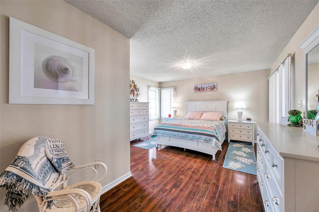 2700 Nebraska Avenue, Unit 3201 Palm Harbor, FL 34684 - Photo 32 of 50 a bedroom with a bed and wooden floor