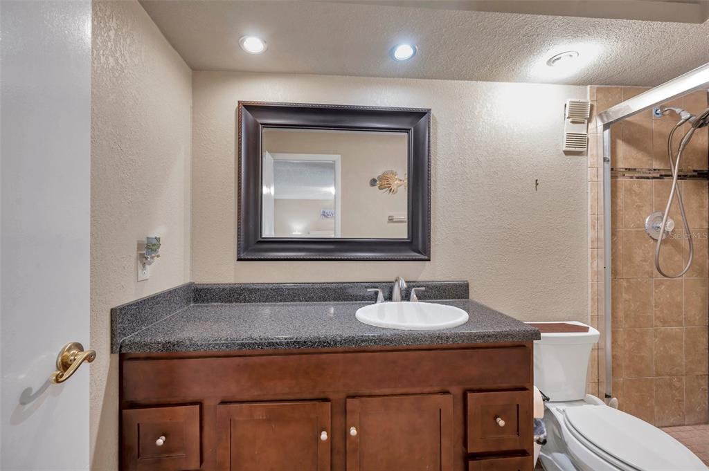 2700 Nebraska Avenue, Unit 3201 Palm Harbor, FL 34684 - Photo 38 of 50 a bathroom with a toilet sink vanity and mirror