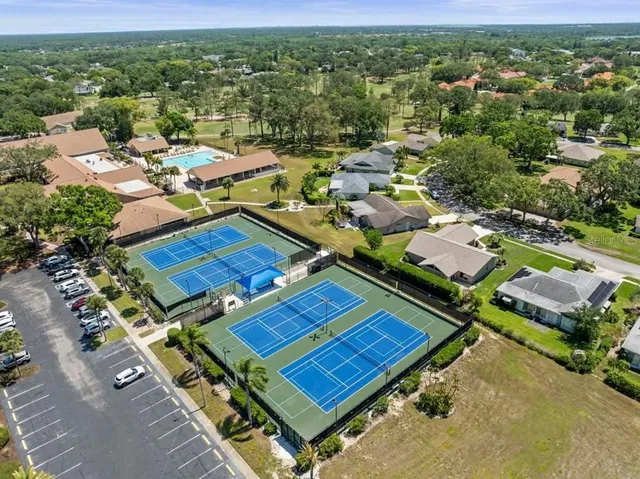 an aerial view of a house with garden space and ocean view