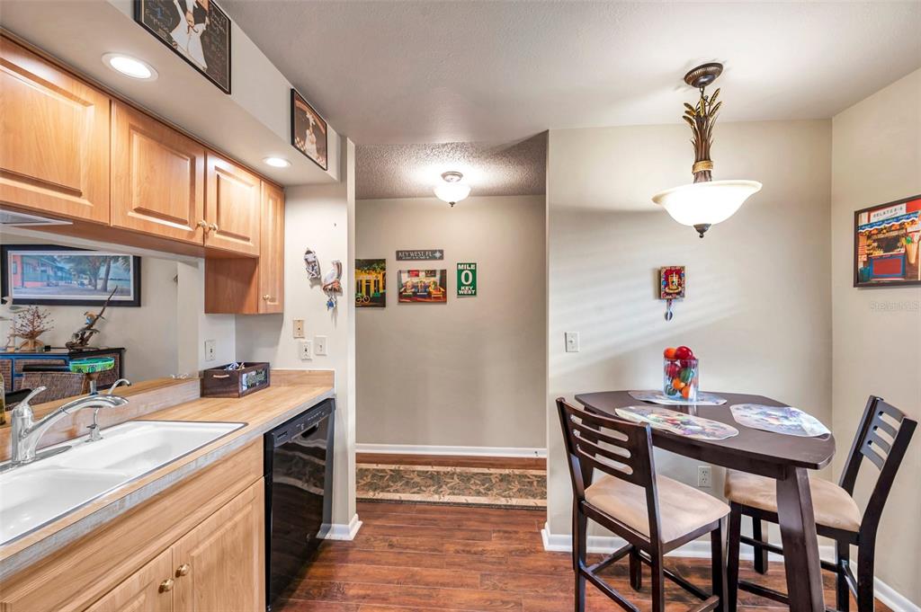 2700 Nebraska Avenue, Unit 3201 Palm Harbor, FL 34684 - Photo 8 of 50 a kitchen with a dining table and chairs in it