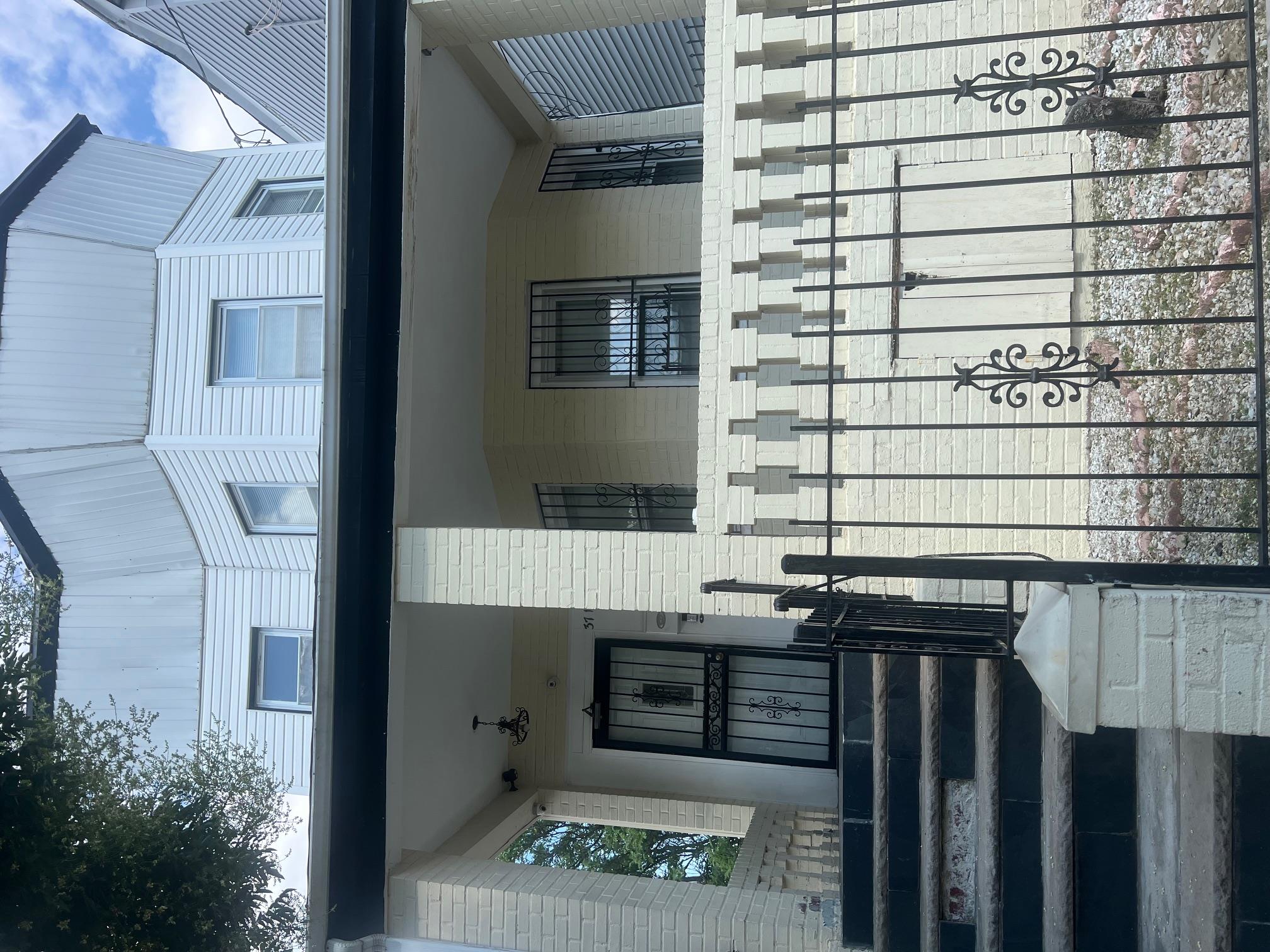 a view of a brick house with many windows