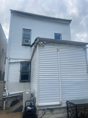 a side view of a house with a balcony