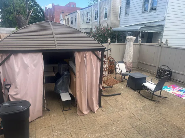 a view of a patio with table and chairs under an umbrella