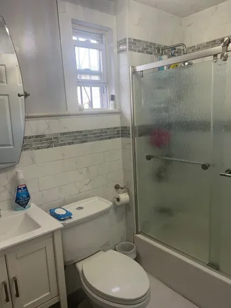 a bathroom with a shower a toilet and a sink