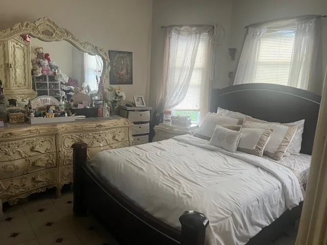 a bedroom with a bed and window