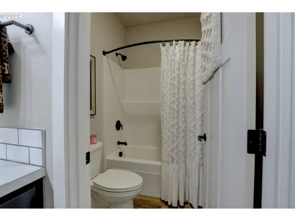 a bathroom with a shower a toilet and a sink
