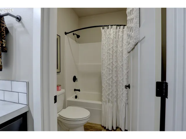 a bathroom with a shower a toilet and a sink