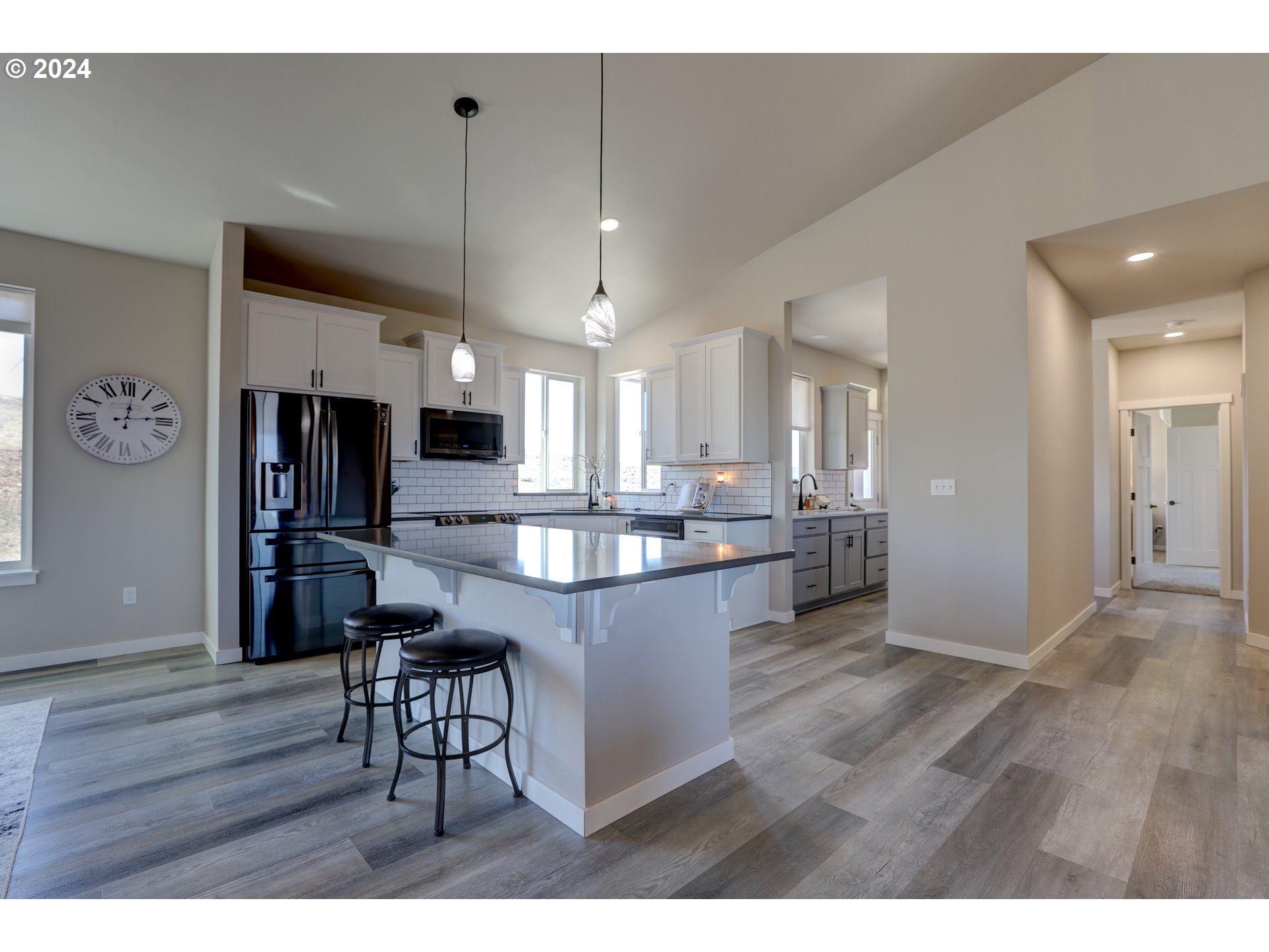 700 Dooley Road Centerville, WA 98613 - Photo 16 of 47 a open kitchen with stainless steel appliances granite countertop a refrigerator a stove a sink dishwasher and white cabinets with wooden floor