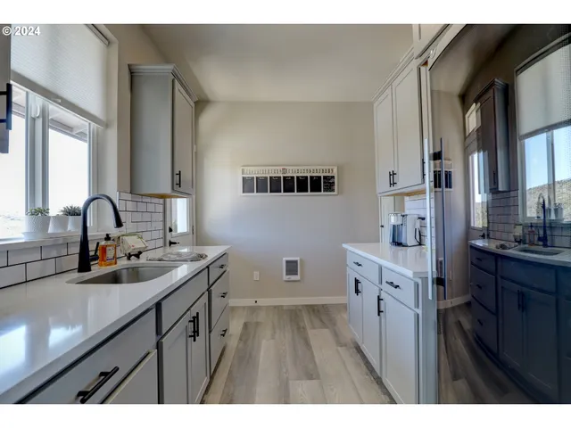 a kitchen with a sink stove and cabinets