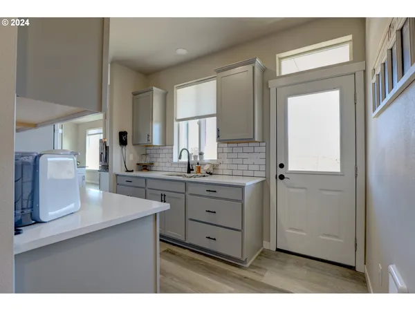 a kitchen with cabinets appliances and a counter top