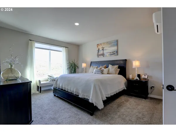 a spacious bedroom with a bed and window