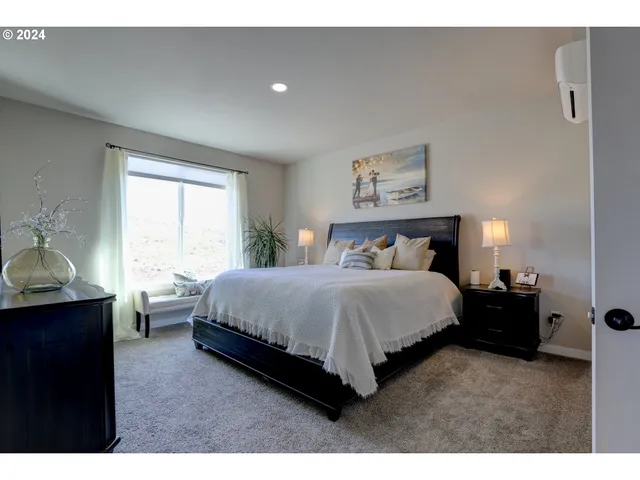 a spacious bedroom with a bed and window