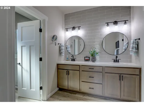 a bathroom with 2 sink and a mirror