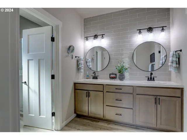 a bathroom with 2 sink and a mirror