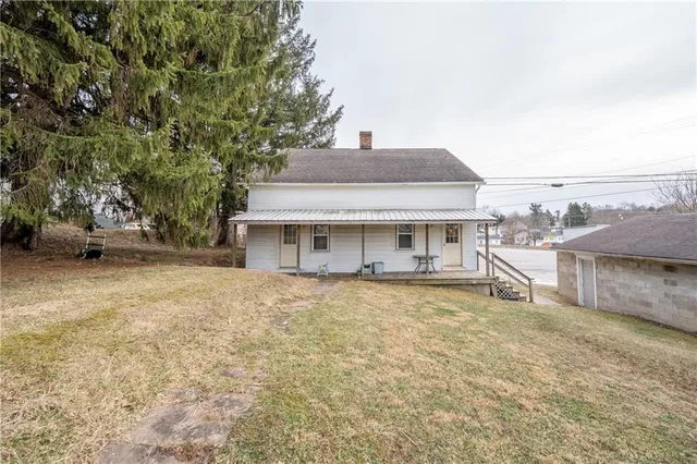 a front view of a house with a garden