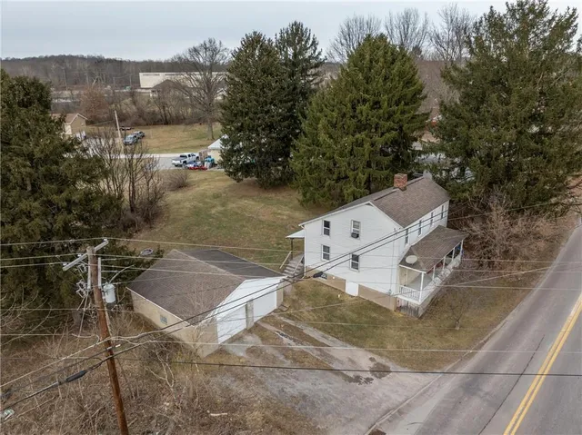 an aerial view of a house with outdoor space