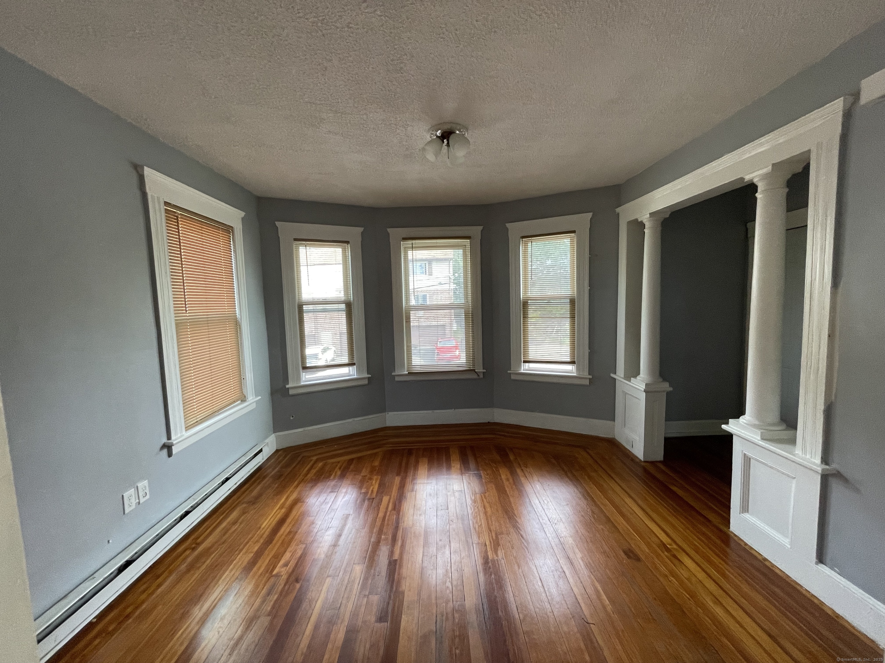 152 Wolcott Street, Unit 2 Waterbury, CT 06705 - Photo 3 of 12 a view of hallway with windows and wooden floor