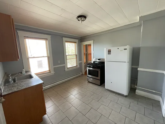 a kitchen with a refrigerator and a stove top oven
