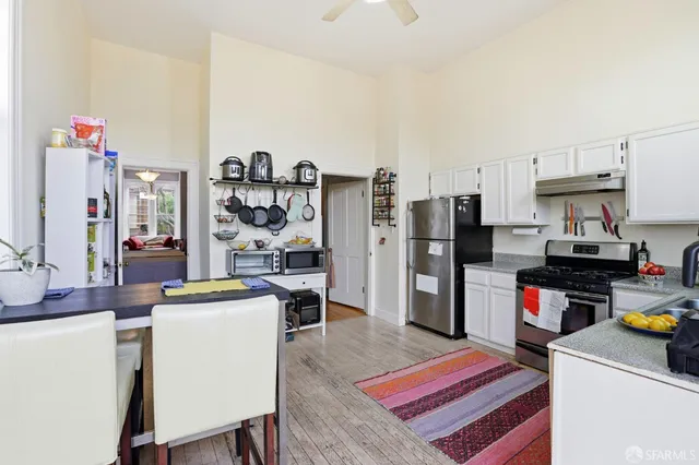 a room with stainless steel appliances lots of appliances and furniture