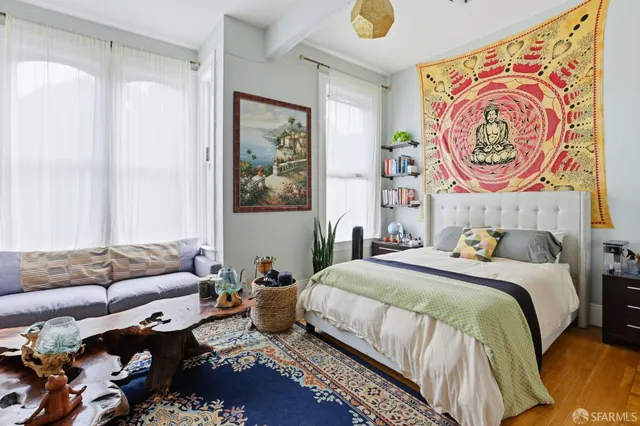 a bedroom with bed and wall painting on the wall