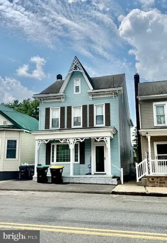 a front view of residential houses with a yard