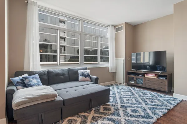 a living room with furniture and a flat screen tv