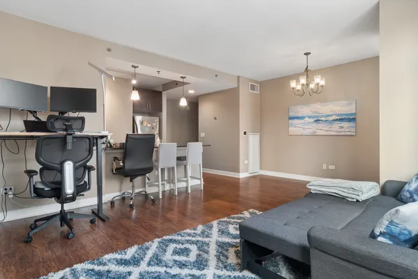 a living room with furniture and a chandelier