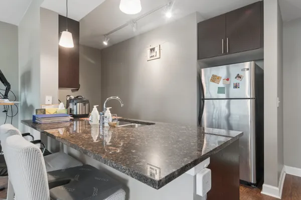 a kitchen with a table chairs and cabinets
