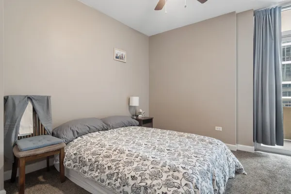 a bedroom with a bed and chair