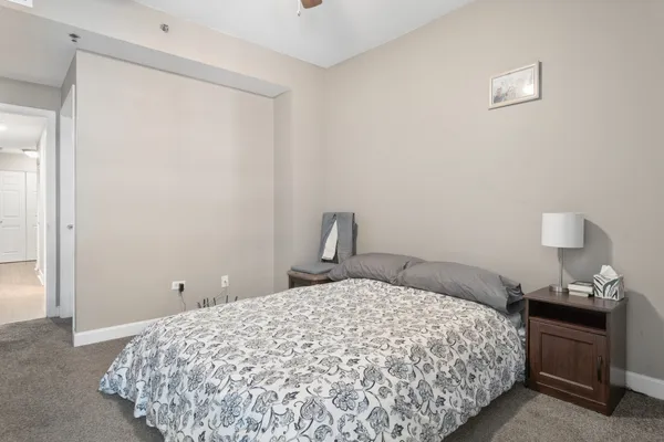 a bedroom with a bed and a lamp