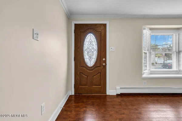 a view of a livingroom with wooden floor and a window
