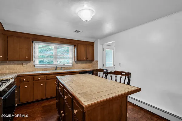 a kitchen with a stove a sink and a refrigerator