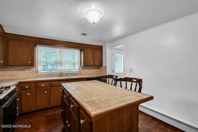 a kitchen with a stove a sink and a refrigerator