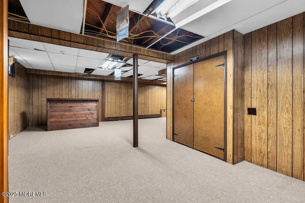 a view of green field with tress in the background