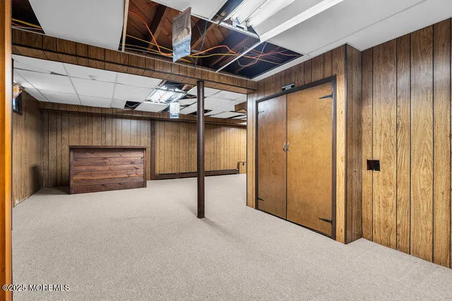 a view of green field with tress in the background