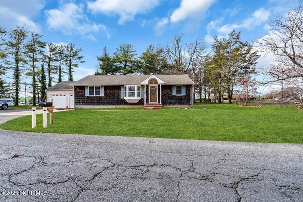 a front view of house with yard and green space