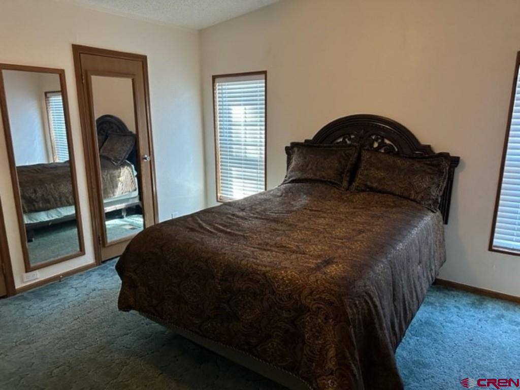 32 Hidden Lane Durango, CO 81303 - Photo 14 of 26 a bed sitting in a bedroom next to a window