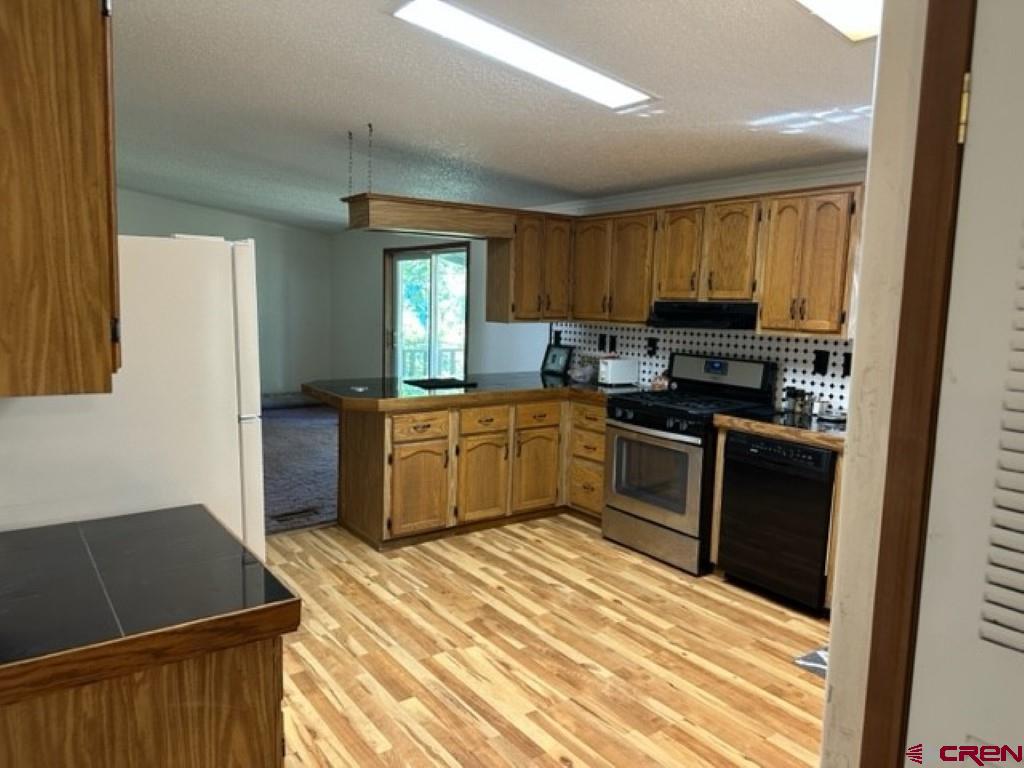 32 Hidden Lane Durango, CO 81303 - Photo 18 of 26 a kitchen with a sink a stove and cabinets
