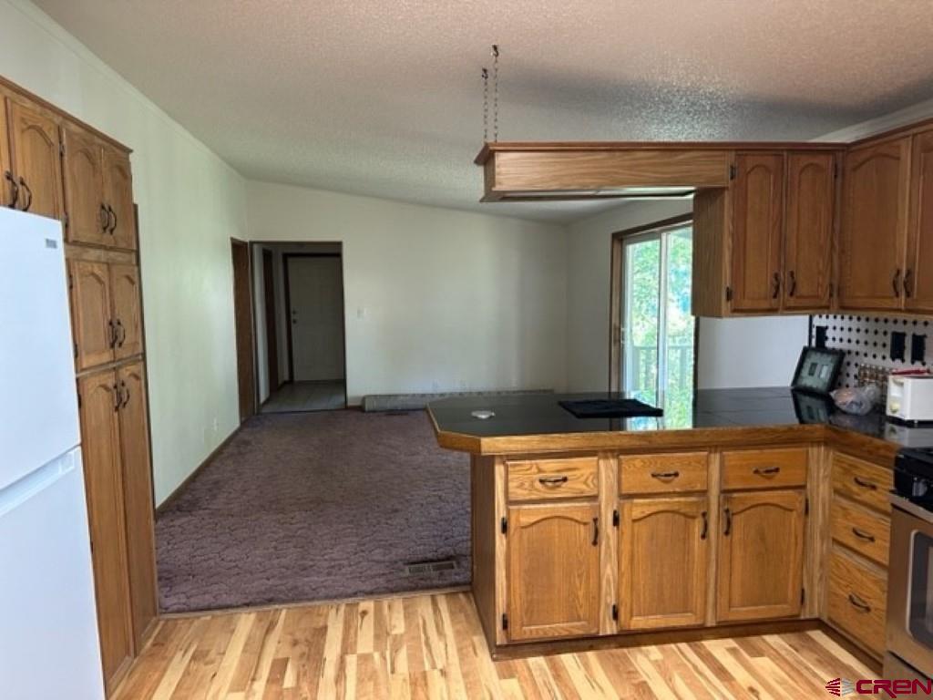 32 Hidden Lane Durango, CO 81303 - Photo 19 of 26 a kitchen with stainless steel appliances granite countertop a stove a sink and a refrigerator