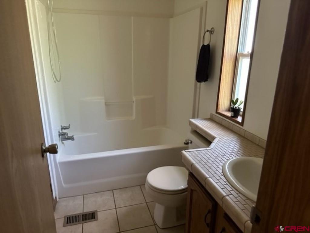 32 Hidden Lane Durango, CO 81303 - Photo 23 of 26 a bathroom with a granite countertop sink toilet and bathtub